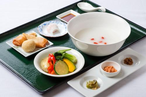 a tray with a bowl and plates of food on it at The Meibia Miyazaki in Miyazaki