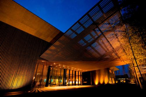 a large building with lights on the side of it at The Meibia Miyazaki in Miyazaki