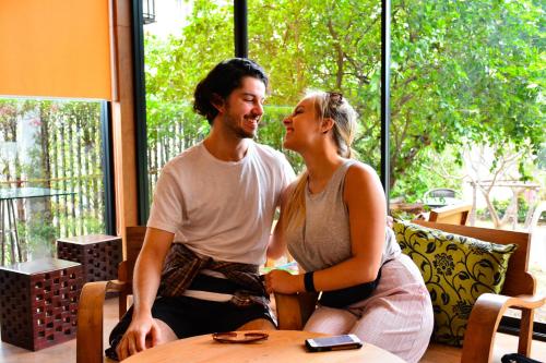 a man and a woman sitting at a table at The Choice Hotel - Adults Only in Bangkok