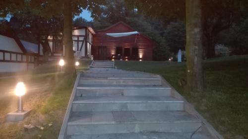 a group of stairs leading to a house at night at Chata nad Sztolnią in Bystrzyca Górna
