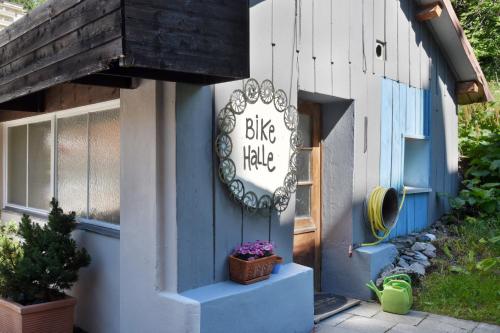 a blue building with a big hug hive sign on it at Hotel Seehof-Arosa in Arosa
