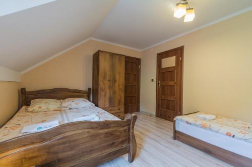 a bedroom with two beds in a room at Pod Brzozka in Cisna