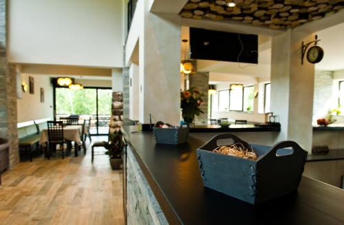 a kitchen with a black counter with a dining room at Pension Pîrîu' Morii in Gura Humorului