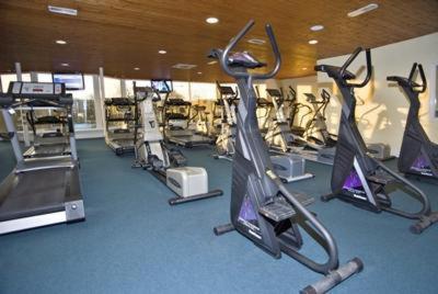 a gym with rows of tread machines in a room at Woodlands Hotel & Leisure Centre in Waterford