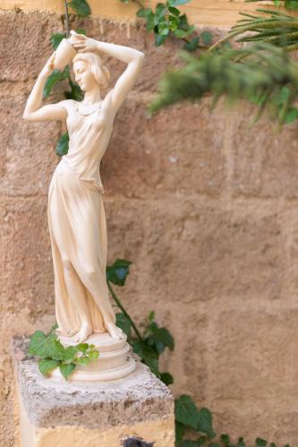 a statue of a woman standing on a wall at Kristina´s rooms in Rhodes Town