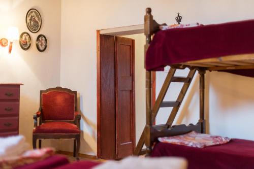 a bedroom with a bunk bed and a chair at Kristina´s rooms in Rhodes Town