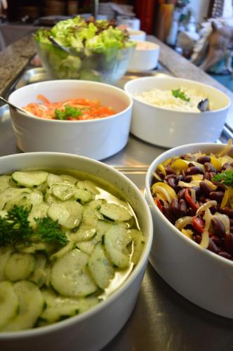 a group of bowls of food on a table at Alemannenhof Hotel Engel in Rickenbach