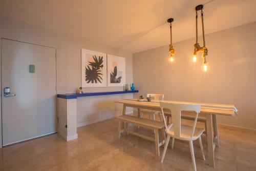 a dining room with a wooden table and chairs at OCEAN VIEW DELUXE SUITE: PVT. BEACH & POOL in San Juan