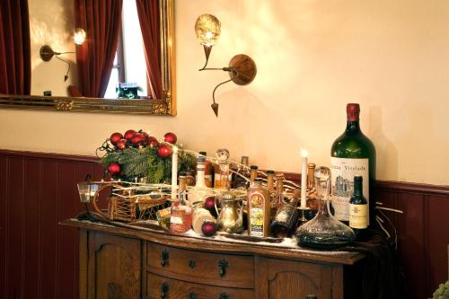 a bunch of bottles of alcohol on a table at Hotel Restaurant in den Hoof in Maastricht