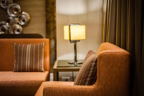 a living room with a couch and a table with a lamp at Green World Taipei Station in Taipei