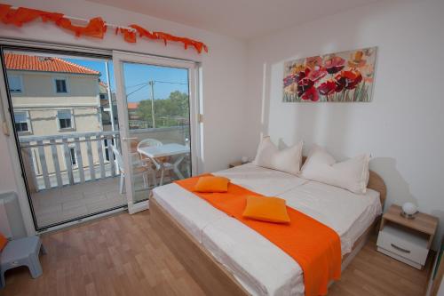 a bedroom with a bed and a large window at Apartments Lucia in Podstrana