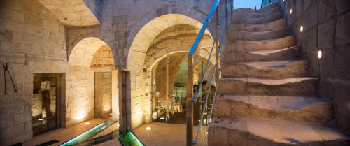 a stone hallway with stairs in a building at Corte Dei Francesi in Maglie