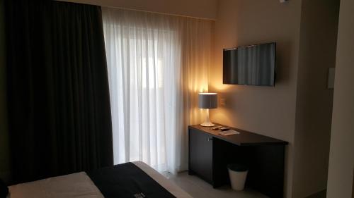 Телевизор и/или развлекательный центр в Porto Cesareo Exclusive Room