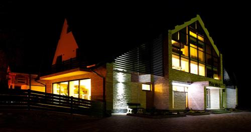 a building with its lights on at night at Pension Pîrîu' Morii in Gura Humorului