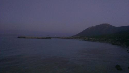 a view of a large body of water at night at Starlit Villa in Kathikas
