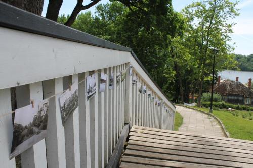 a white fence with pictures on the side of it at Trepimäe Guest Apartment in Viljandi