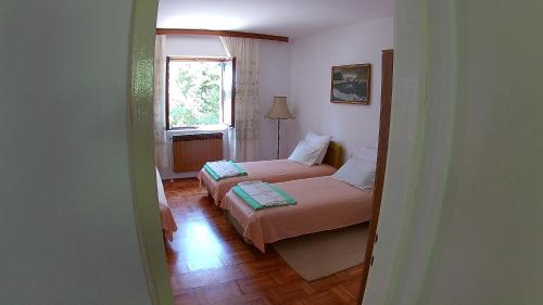 En eller flere senge i et værelse på Vuksanovic Apartment