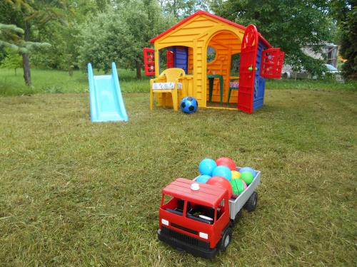 a toy truck in a yard with a toy playground at Ubytovani U babicky in Velké Losiny