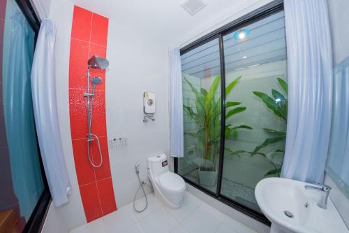 a bathroom with a shower and a toilet and a sink at Rest Time Hotel in Nong Khai
