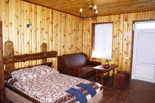 a bedroom with a bed and a chair at Marinus in Gribovka