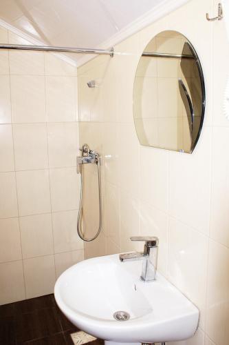 a bathroom with a sink and a shower at Marinus in Gribovka