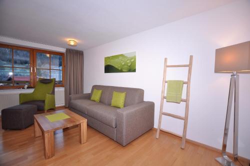 a living room with a couch and a ladder at Berghüs Schratt - EINFACH ANDERS - Ihr vegetarisches und veganes Biohotel in Oberstaufen