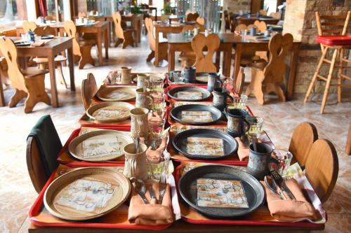 a table topped with plates and bowls of food at Loc'Hotel Alpen Sports in Les Gets