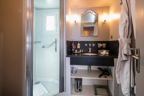 une salle de bain avec un lavabo et une douche dans l'établissement Villa Garbo, à Cannes