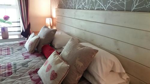 a bedroom with a wooden headboard and a bed with pillows at Swinside Inn in Keswick