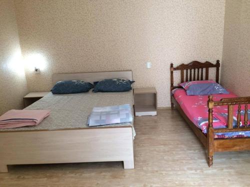 a bedroom with a bed with two pillows on it at Guest House Econom in Mtskheta