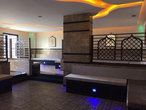 a lobby of a synagogue with benches and lights at Siberland Olive Garden Orion City 7 in Avsallar