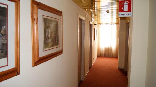 a hallway with paintings on the walls of a building at Hotel Ristorante Novara Expo in Bareggio