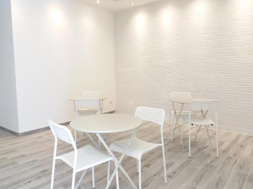 a white table and chairs in a room at Diana's in Stintino