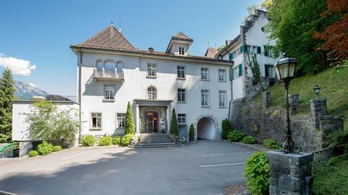 a large white house with a staircase leading to it at Hotel Schloss Ragaz in Bad Ragaz