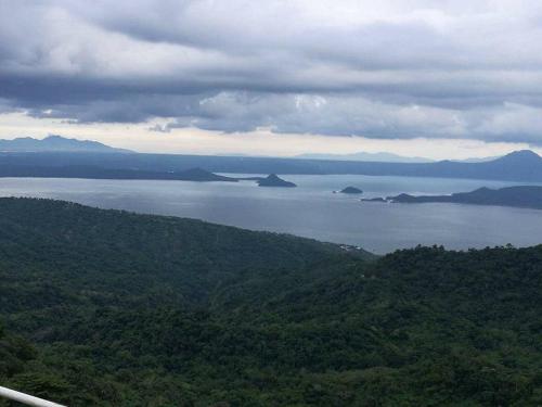 a view of a large body of water with trees at AAA Condominium in Tagaytay
