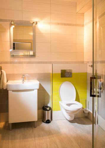 a bathroom with a toilet and a sink at Golf Resort Česká Lípa in Nový Bor