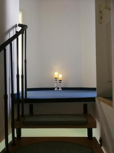 two candles sitting on a bed in a room at Hotel Am Markt in Ehrenfriedersdorf