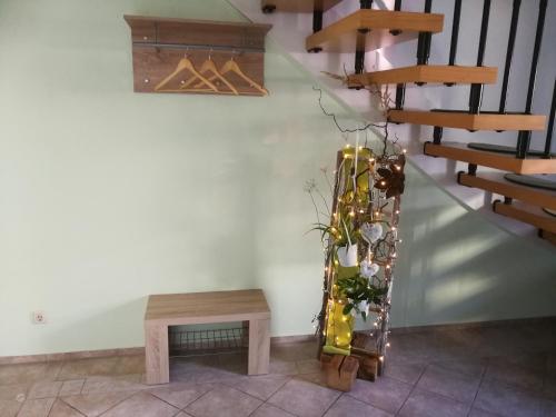 a staircase with a table and a vase of flowers at Hotel Am Markt in Ehrenfriedersdorf