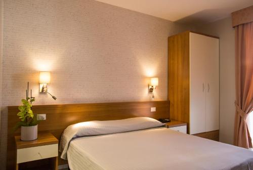 Postel nebo postele na pokoji v ubytování Hotel Lo Scudiero