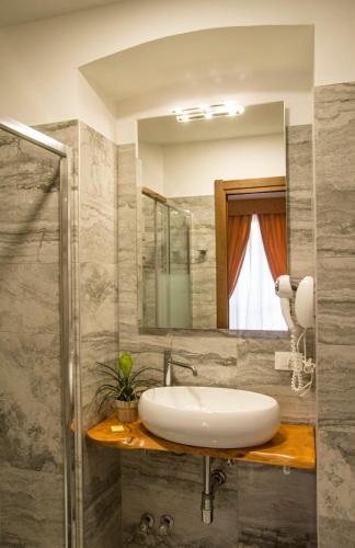 a bathroom with a sink and a mirror at Hotel Lo Scudiero in Turin