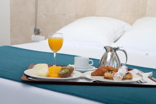 a tray of food and a glass of orange juice at Climia Belroy 4 Sup in Benidorm