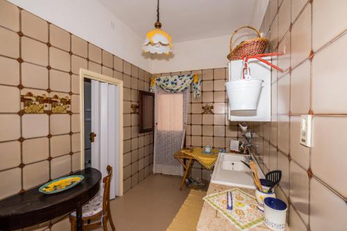 a small kitchen with a sink and a table at Giulia e Pietro - Marettimo Apartments in Marettimo