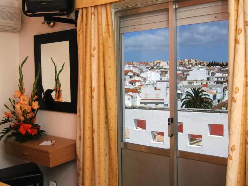a door to a window with a view of a city at Hotel Riomar in Lagos