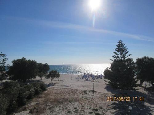 a group of people on a beach near the water at Katerina & Efi Apartments in Mastichari