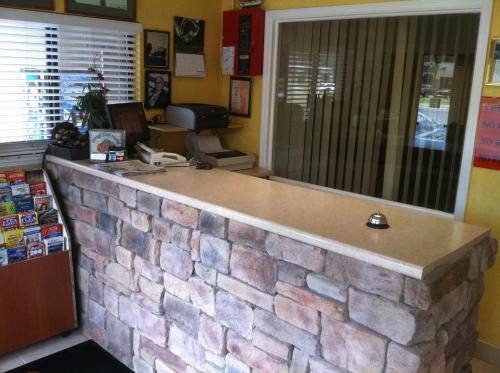 a stone counter in a room with a brick wall at Orange City Motel - Orange City in Orange City