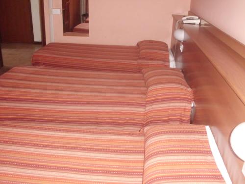 Katil atau katil-katil dalam bilik di Hotel Lombardia