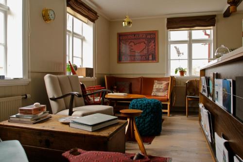 a living room with a table and a couch at Hótel Egilsen in Stykkishólmur