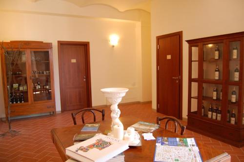 a living room with a table with a vase on it at Agriturismo Il Frantoio Di Colle Alberto in Montale