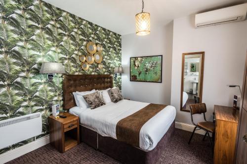 a hotel room with a bed and a mirror at Mercure Nottingham City Centre Hotel in Nottingham