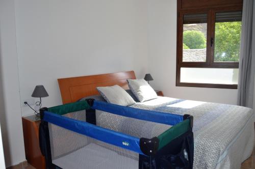 a bed with a blue frame in a bedroom at Apartament Esterri Centre in Esterri d'Àneu